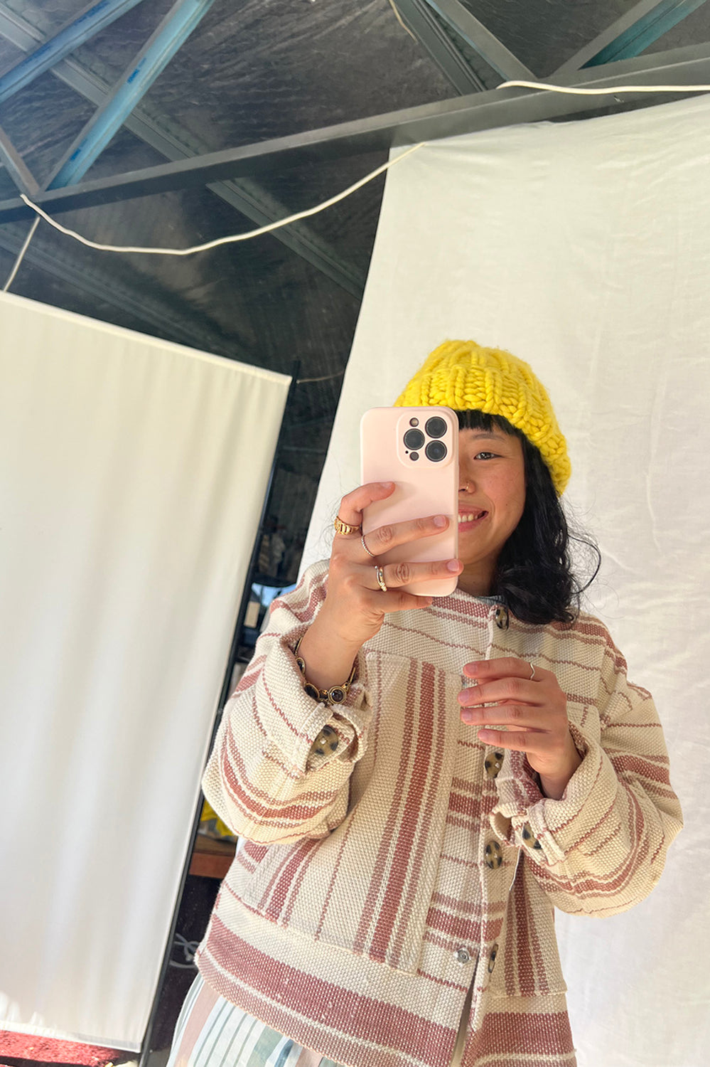 pink striped cotton handwoven jacket worn by a person doing a selfie