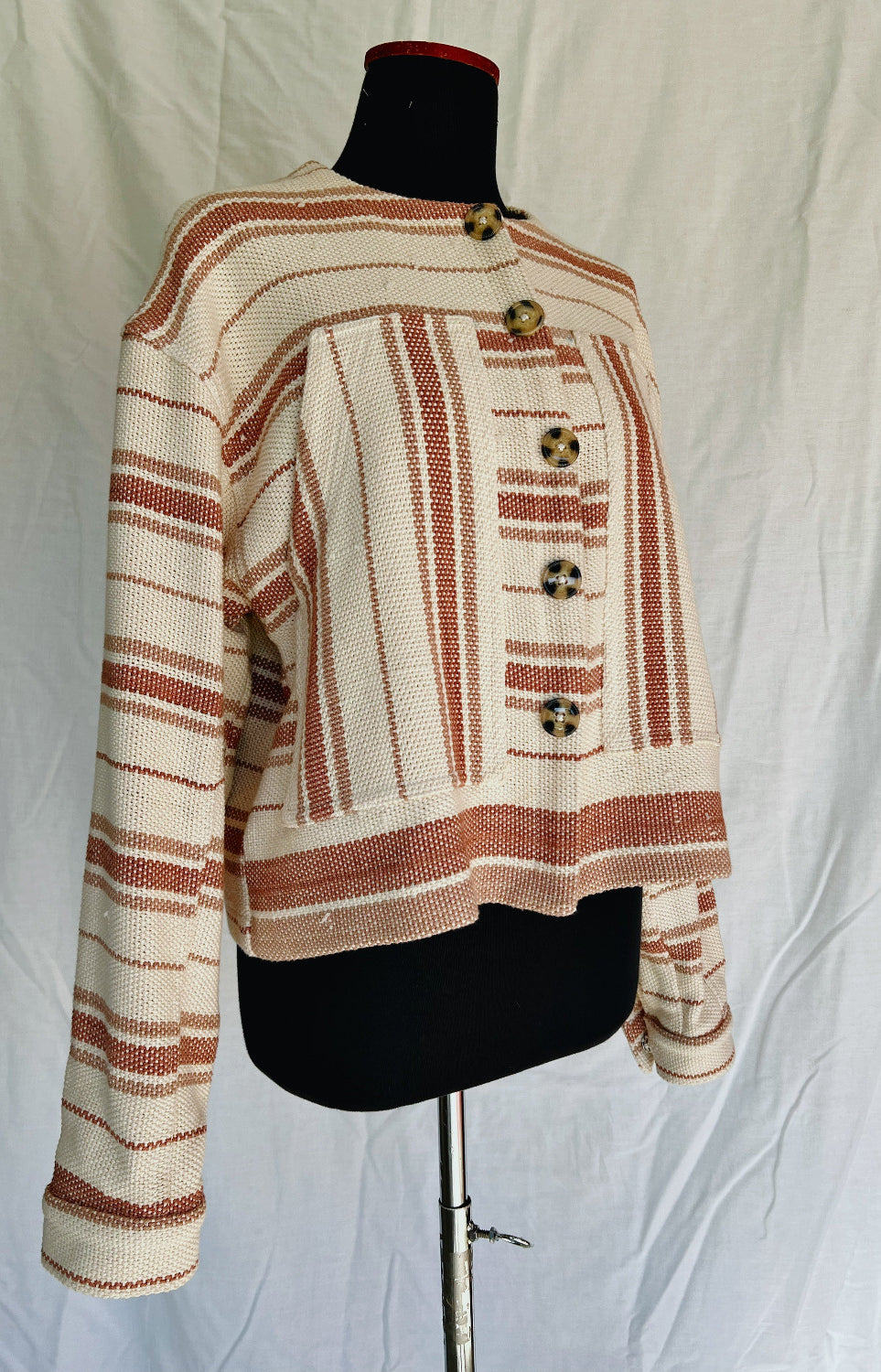 Striped jacket on a mannequin against a plain background