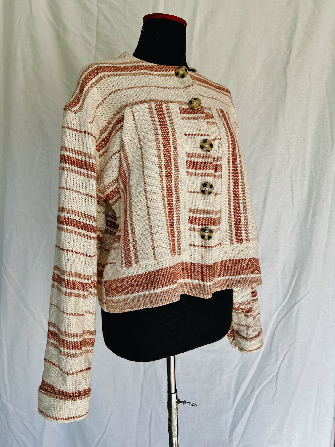 Striped jacket on a mannequin against a plain background