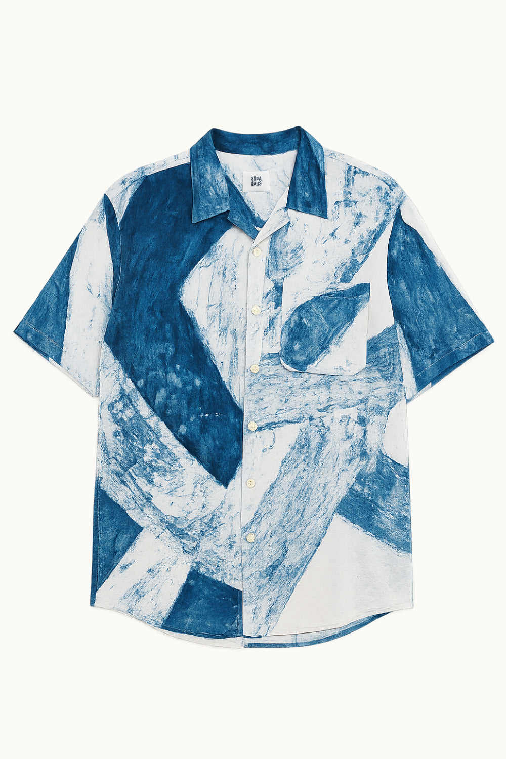 Handpainted Batik in blue and white abstract patterned cotton shirt on a white background