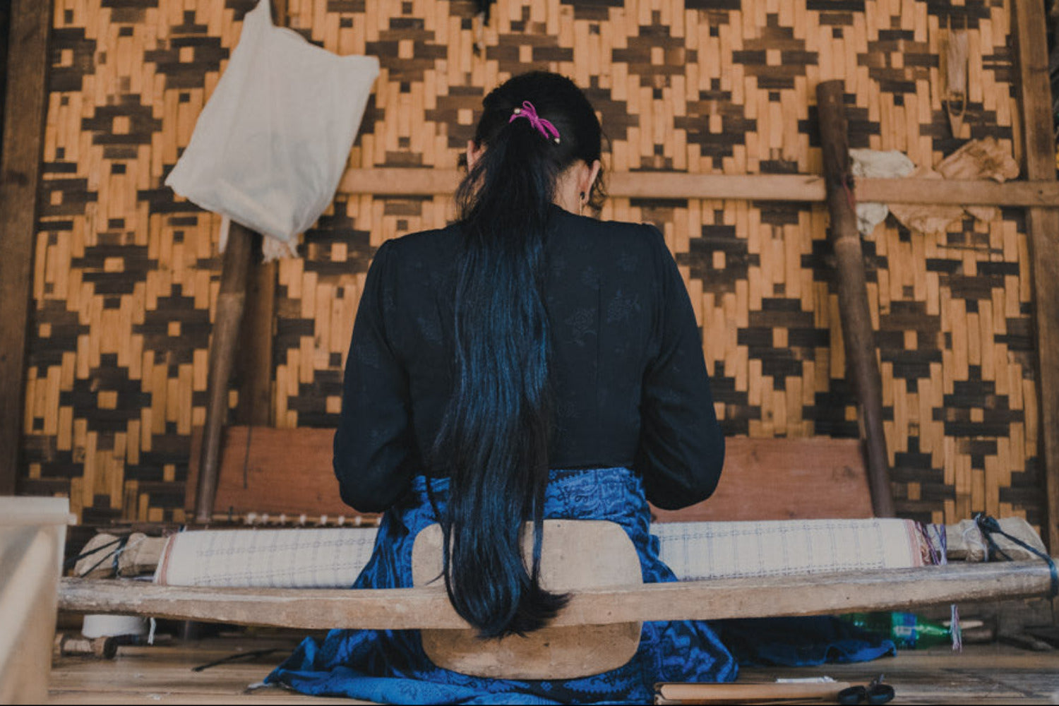 Artisan working at a traditional handloom, weaving textiles as part of RŪPAHAUS’ long-term partnership-led production.