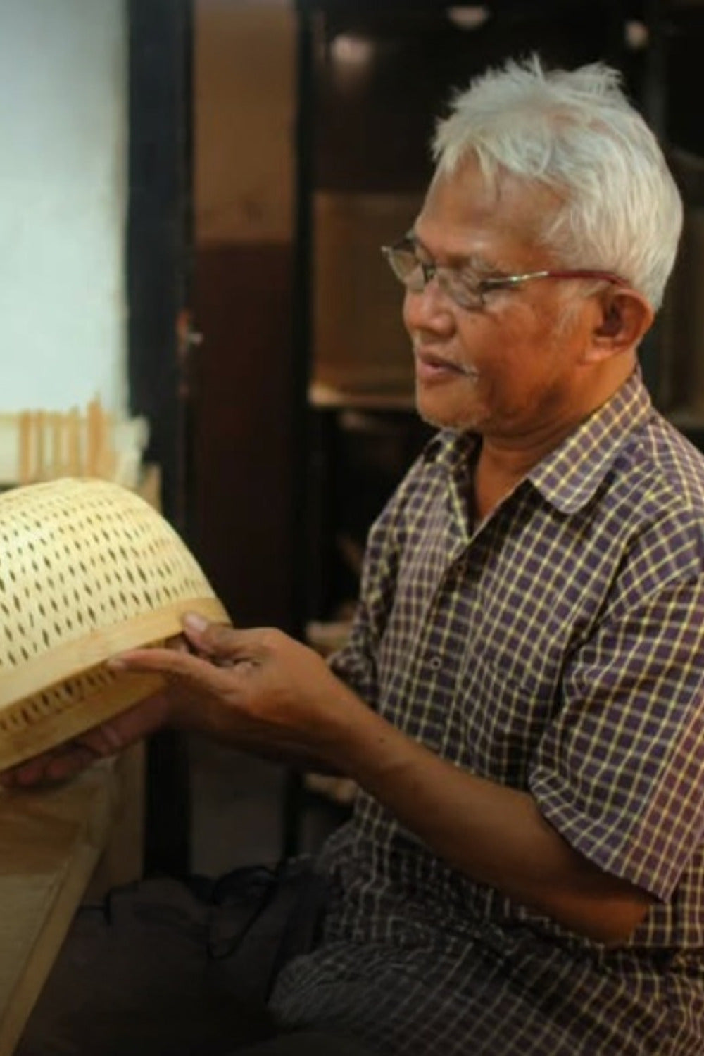 RUPAHAUS artisans weaving handmade bamboo baskets by hand in a small workshop setting
