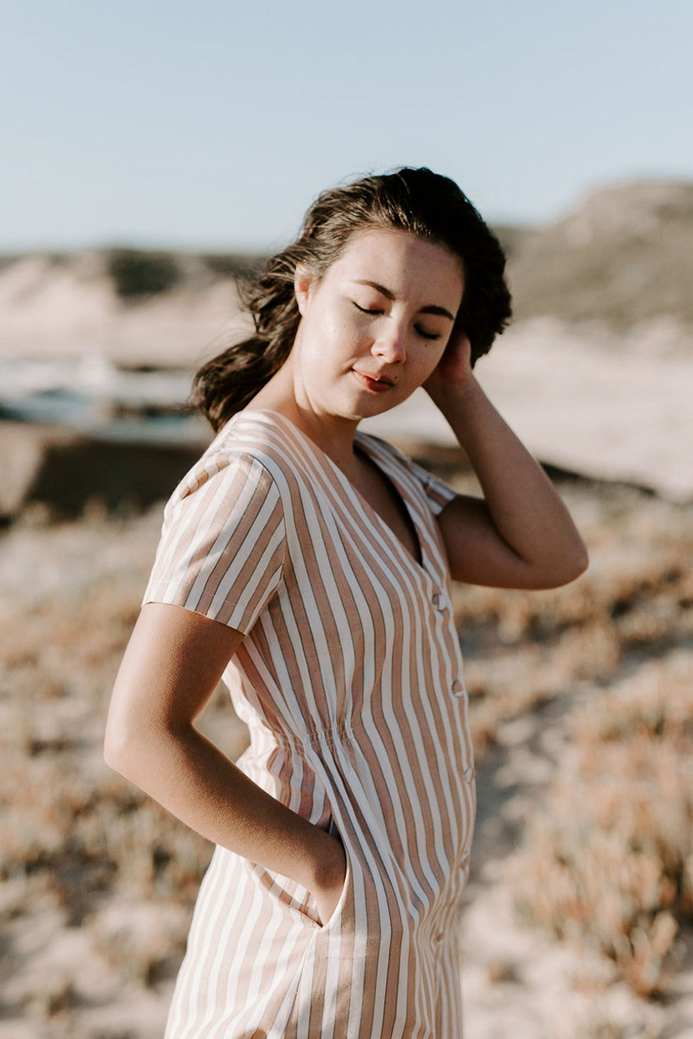 Woman wearing a striped, seasonless dress made from natural fibres, designed for everyday movement and repeated wear.