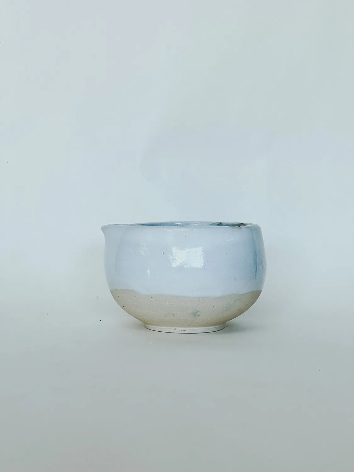 Ceramic bowl with two-tone design on a light gray background