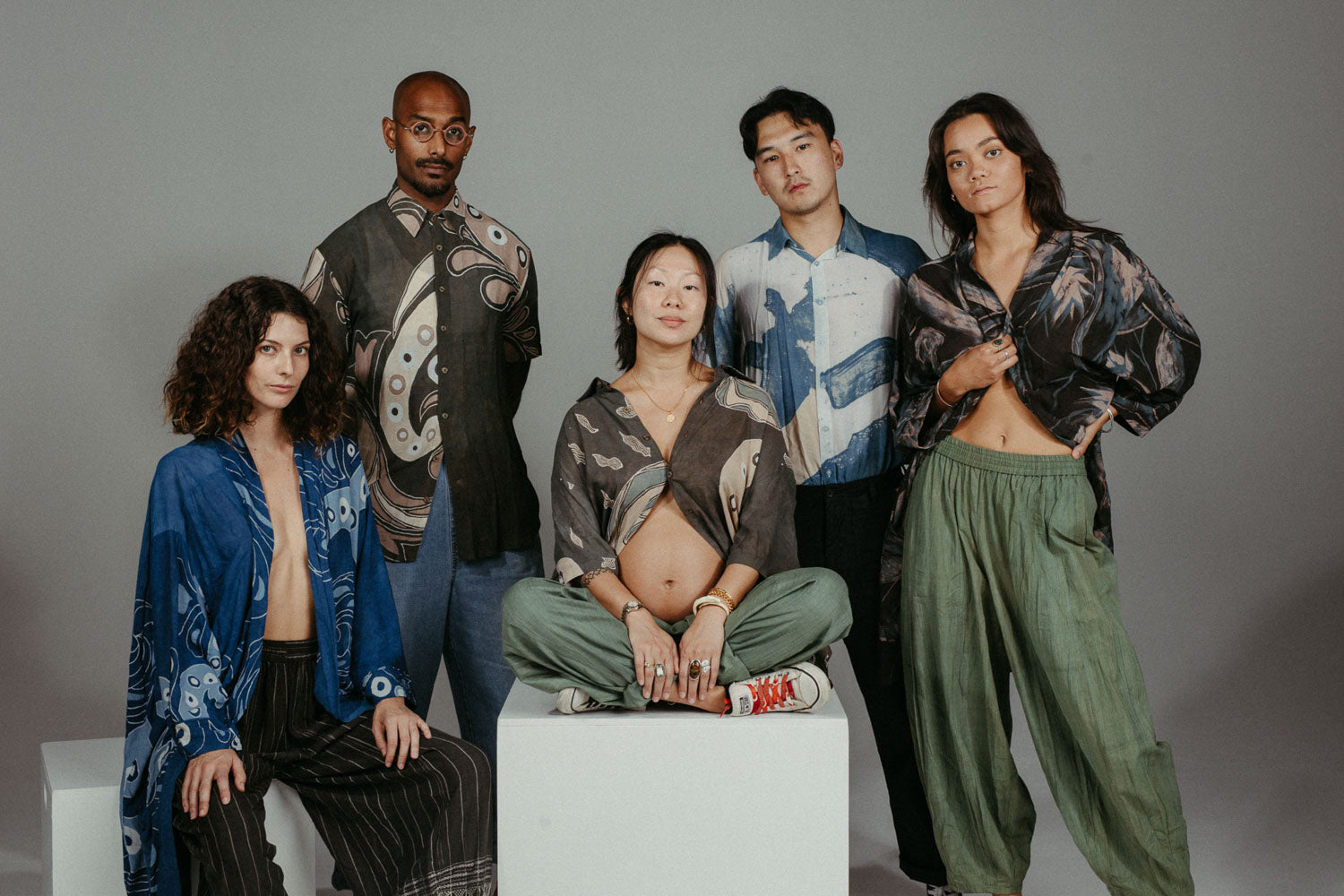 Models wearing handcrafted RUPAHAUS garments made with traditional Indonesian textiles, styled together for a shop the look feature.