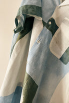 Handpainted Batik Camp Shirt in blue, green and natural hues with relaxed collar and short sleeves, worn by a male model