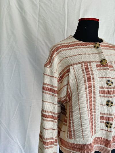 Textured jacket with striped pattern on a mannequin against a white background