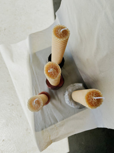 Handrolled Beeswax on candle holders photographed from above