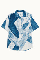 Handpainted Batik in blue and white abstract patterned cotton shirt on a white background