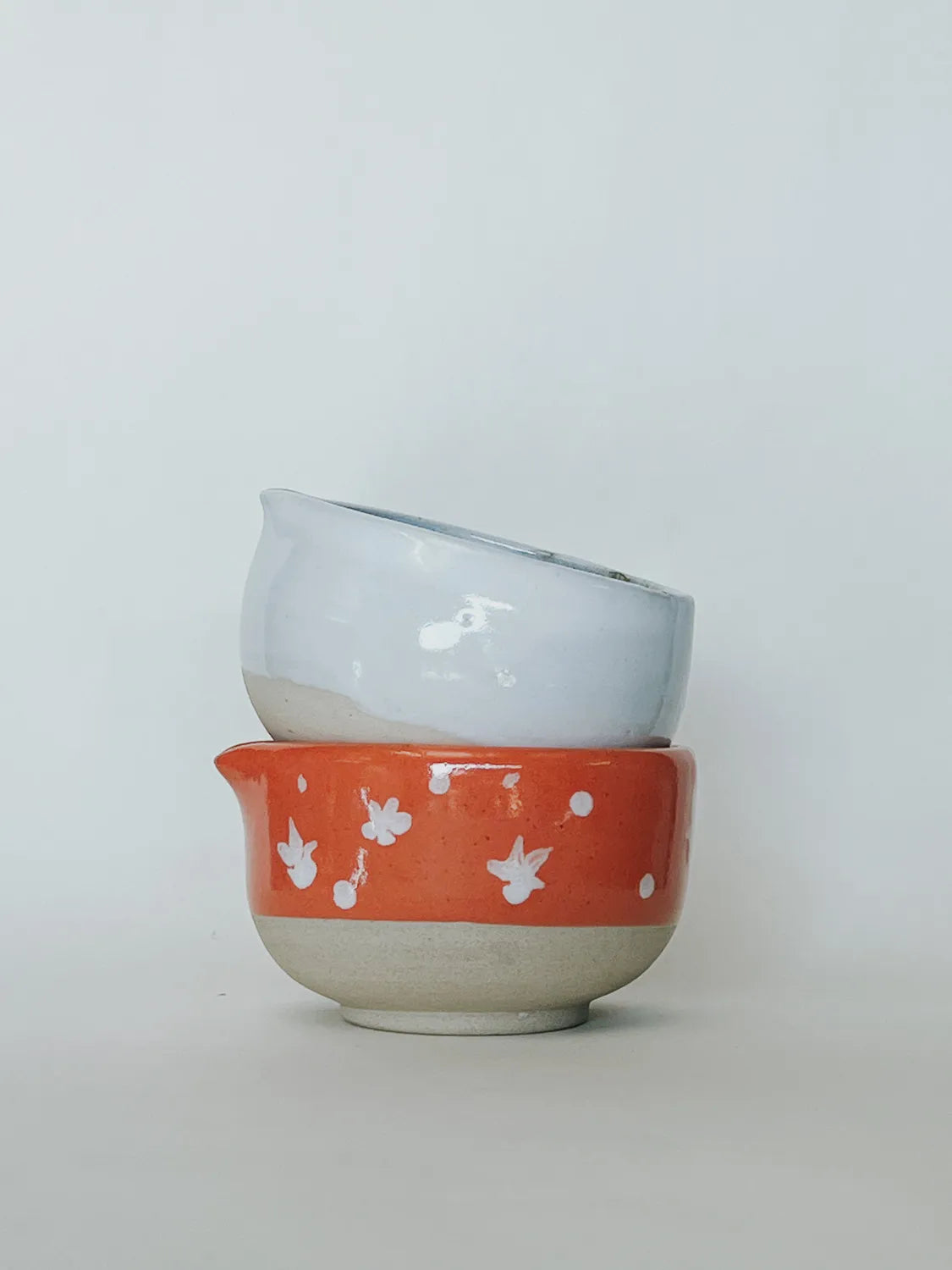 Two ceramic bowls stacked on a white background