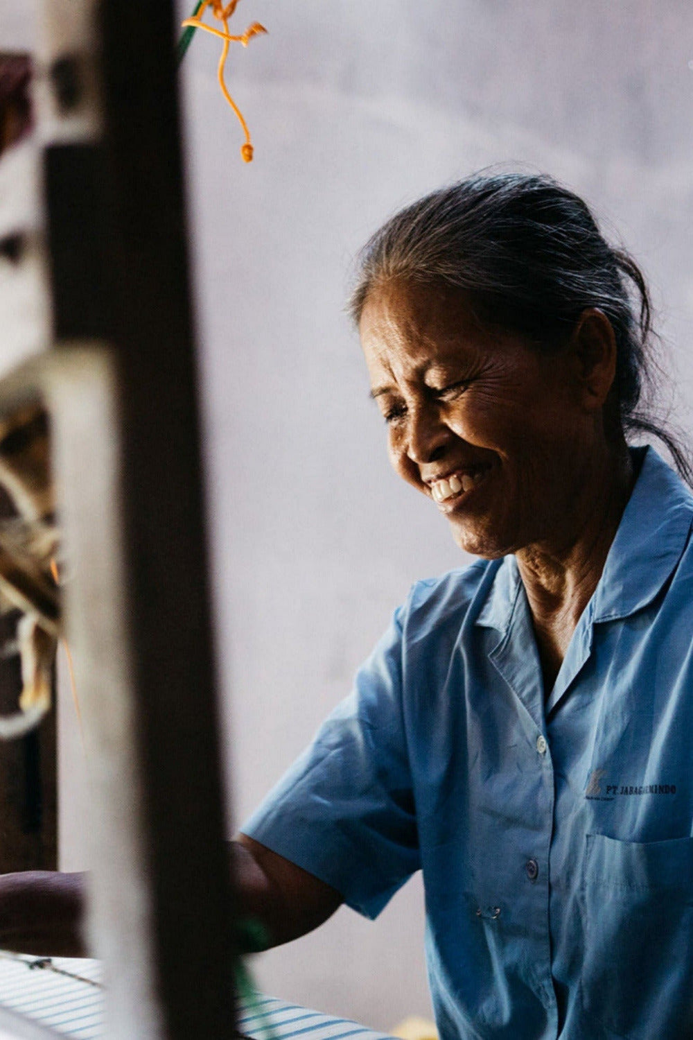 Lorek weaver working on a loom with a 