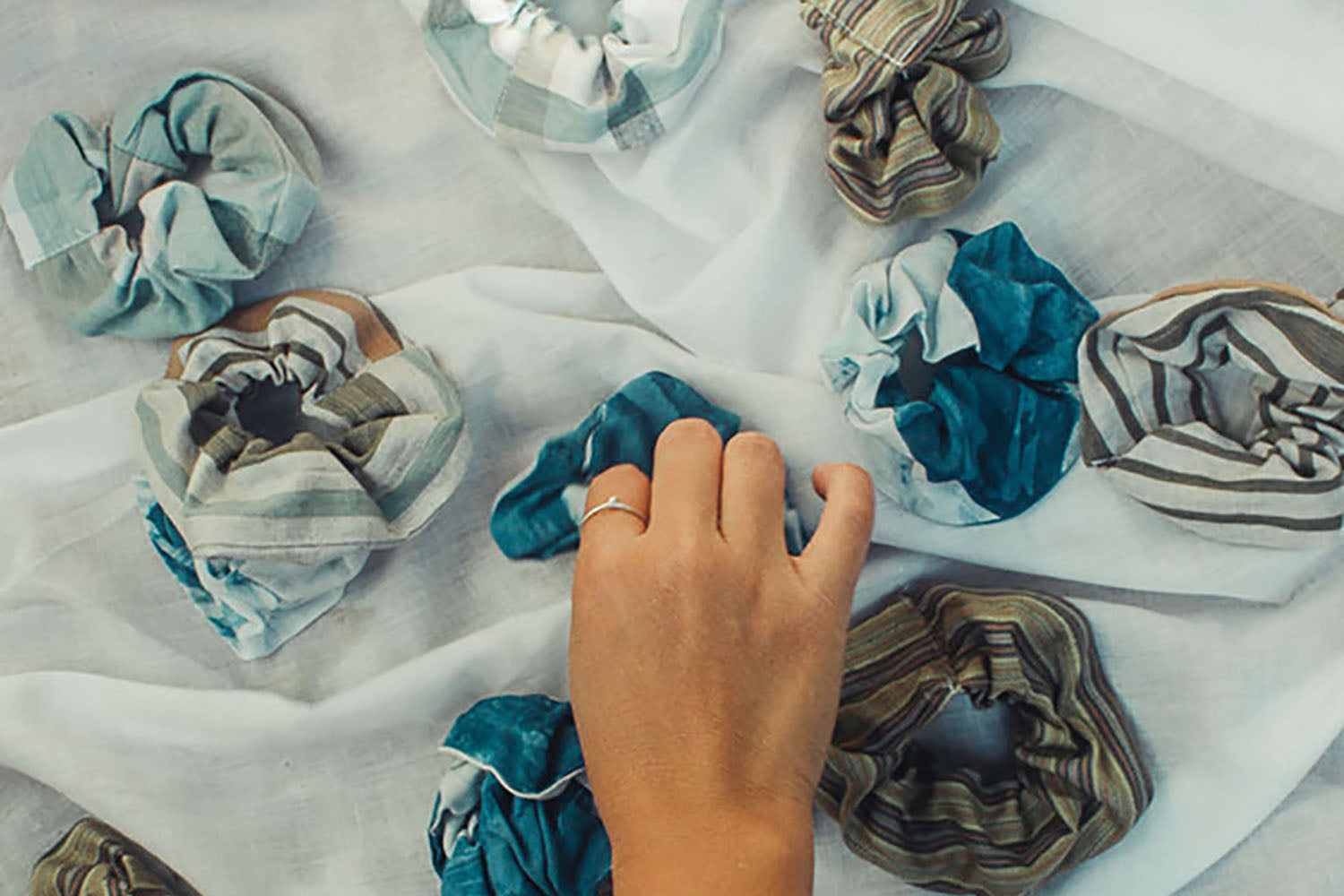 Handwoven re:rupa upcycled organic cotton scrunchies dyed with natural dyes using traditional techniques
